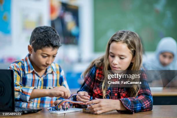 two multi-ethnic elementary students working on a stem project stock photo - pcb board stock pictures, royalty-free photos & images