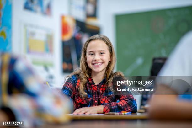 elementary school girl coloring in class stock photo - afghani stock pictures, royalty-free photos & images