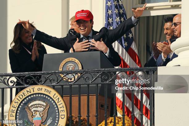 President Donald Trump embraces Washington National catcher Kurt Suzuki as he wears a 'Make America Great Again' cap during a celebration of the 2019...