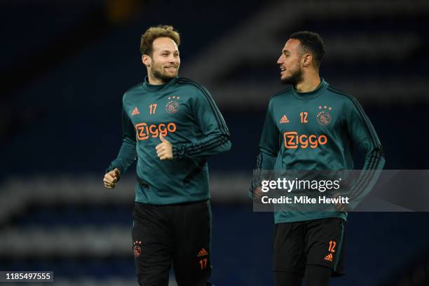 Daley Blind of AFC Ajax and Noussair Mazraoui of AFC Ajax arrive for a training session ahead of their UEFA Champions League Group H match against...