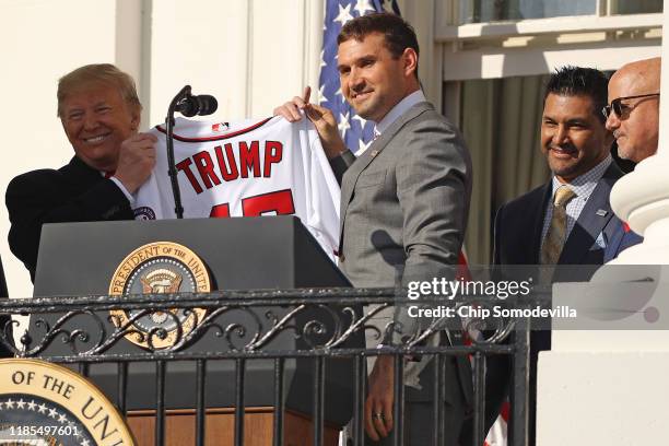 Washington Nationals first baseman Ryan Zimmerman presents U.S. President Donald Trump with a team jersey during a celebration of the 2019 World...