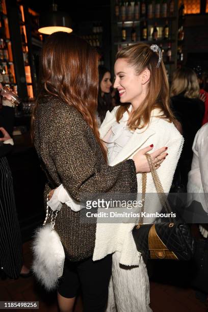 Grace Gummer and Dianna Agron, both wearing Chanel, hug at Through Her Lens: The Tribeca CHANEL Women's Filmmaker Program Luncheon at Locanda Verde...