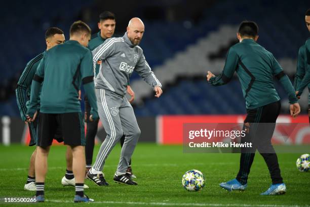 Erik Ten Hag, Manager of Ajax passes the ball during a training session ahead of their UEFA Champions League Group H match against Chelsea at...