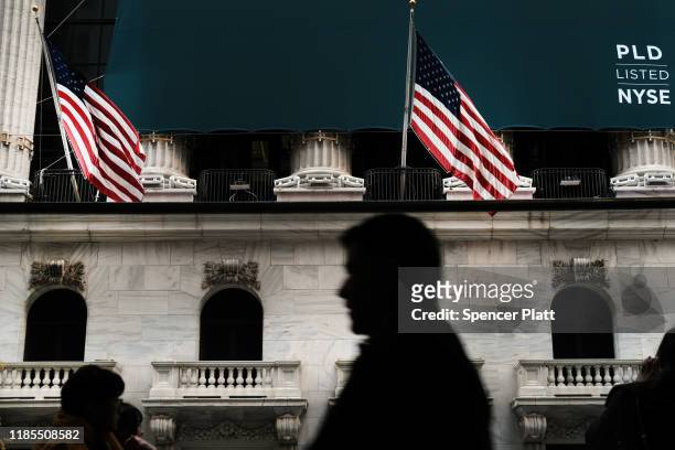 People walk by the New York Stock Exchange on November 04, 2019 in New York City. U.S. Stocks finished at records highs on Monday with the Dow Jones...