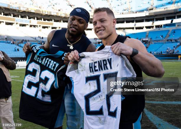 Christian McCaffrey of the Carolina Panthers and Derrick Henry of the Tennessee Titans trade jerseys after the game during a game between Tennessee...
