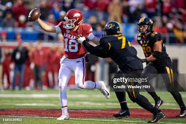 Jack Lindsey of the Arkansas Razorbacks tries to get away from the tackle of Kobie Whiteside of the Missouri Tigers in the second half of a game at...