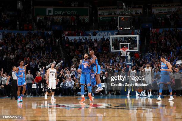 Steven Adams, and Chris Paul of the Oklahoma City Thunder react to a play against the New Orleans Pelicans on November 29, 2019 at Chesapeake Energy...