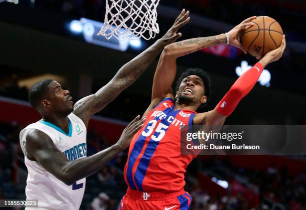 Christian Wood of the Detroit Pistons goes to the basket against Marvin Williams of the Charlotte Hornets during the second half at Little Caesars...