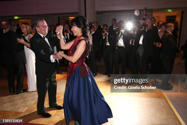 Former Chancellor Gerhard Schroeder and his wife Kim So-yeon Schroeder dance during the 68th Bundespresseball at Hotel Adlon on November 29, 2019 in...