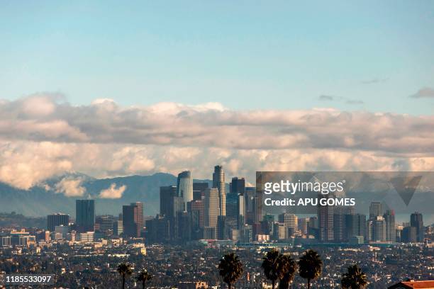 View of the downtown Los Angeles skyline with the snow-covered San Gabriel Mountains in the background on November 29, 2019 in Los Angeles,...