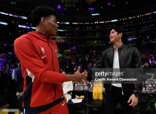 Rui Hachimura of the Washington Wizards and Shohei Ohtani of the Los Angeles Angels of Anaheim greet each other before the start of a basketball game...
