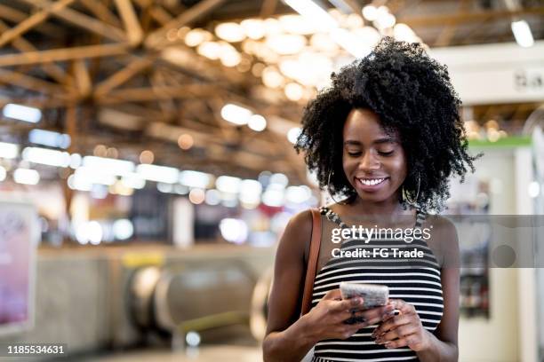 young woman using smartphone in a subway station - automotive trend stock pictures, royalty-free photos & images