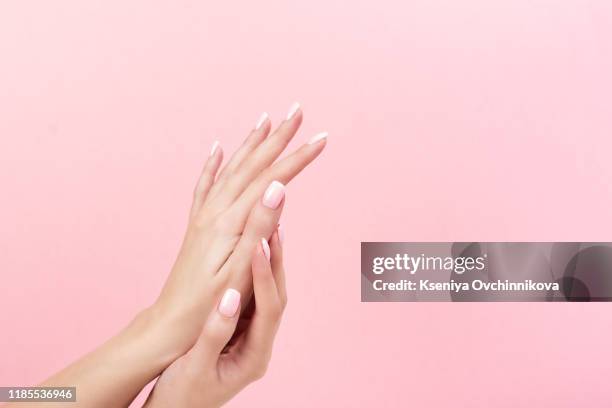 tender hands with perfect blue and pink manicure on trendy pastel pink background. place for text. - manucure photos et images de collection