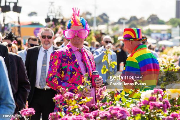 Men in colorful suits are seen during 2019 Melbourne Cup Day at Flemington Racecourse on November 05, 2019 in Melbourne, Australia.
