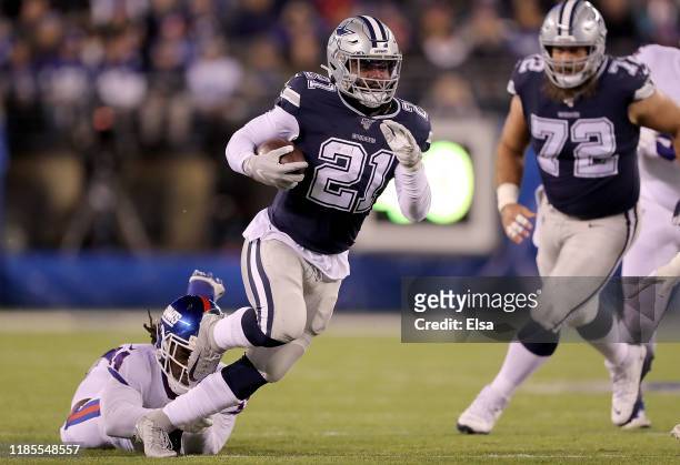 Running back Ezekiel Elliott of the Dallas Cowboys rushes against the defense of the New York Giants during the game at MetLife Stadium on November...