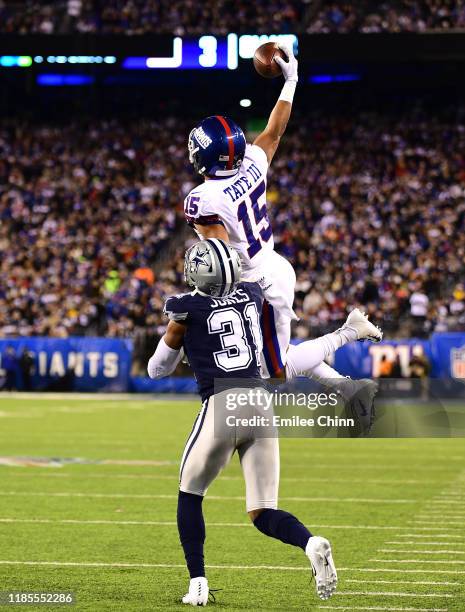 Golden Tate of the New York Giants makes a one-handed catch as Byron Jones of the Dallas Cowboys tries to tackle him during the second quarter of...