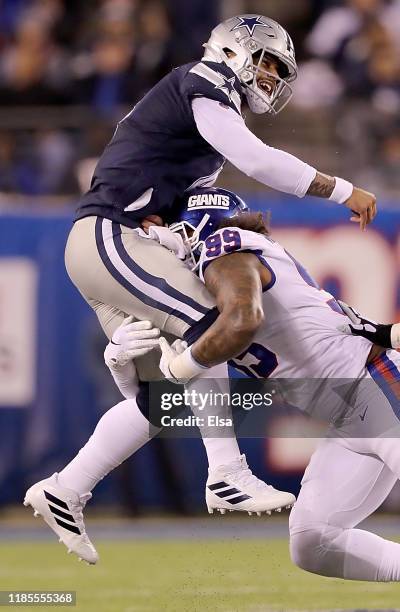 Quarterback Dak Prescott of the Dallas Cowboys is pressured to over throw the ball by defensive end Leonard Williams of the New York Giants in the...