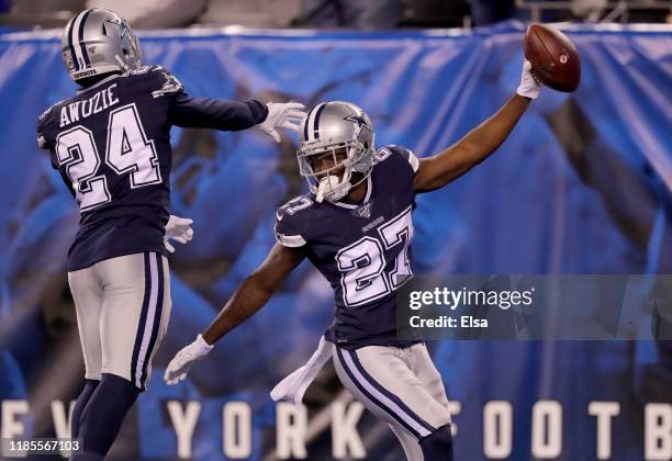 Jourdan Lewis of the Dallas Cowboys celebrates his touchdown with teammate Chidobe Awuzie after Lewis recovered a fumble by the New York Giants in...