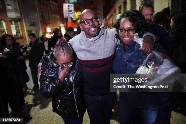 Mary Stewart, left, walks with her son, Andrew Stewart and her daughter, Ulonda Stewart, Andrew's sister after he along with Alfred Chestnut and...