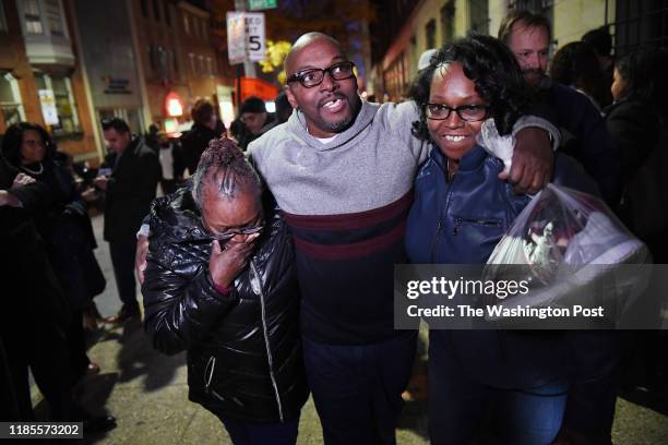 Mary Stewart, left, walks with her son, Andrew Stewart and her daughter, Ulonda Stewart, Andrew's sister after he along with Alfred Chestnut and...