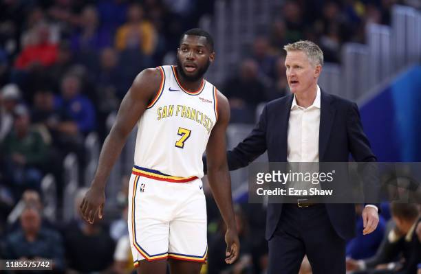Eric Paschall of the Golden State Warriors talks with head coach Steve Kerr during their game against the Portland Trail Blazers at Chase Center on...