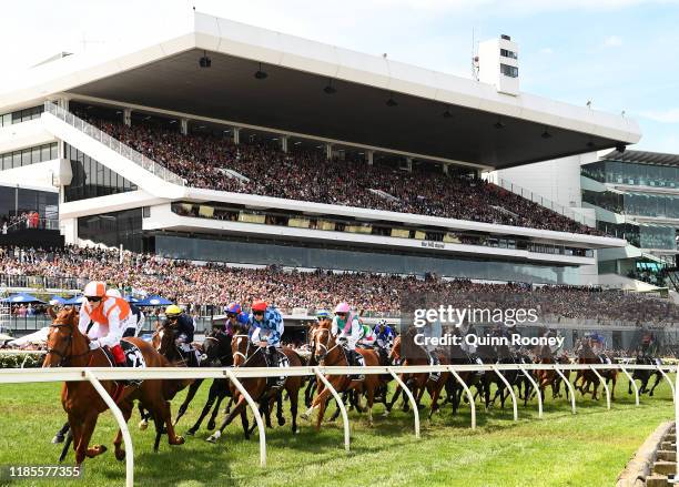 Craig Williams riding Vow and Declare leads the field around the first bend in the Lexus Melbourne Cup during 2019 Melbourne Cup Day at Flemington...