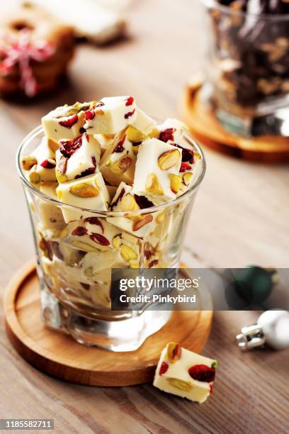 chocolate with pistachio,chocolate and cranberry,white chocolate with cranberries and pistachio,white chocolate,white chocolate bars,christmas decor - trail mix stock pictures, royalty-free photos & images