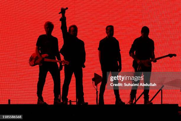 Adam Clayton, Bono, Larry Mullen Jr, The Edge of U2 perform at the National Stadium on November 30, 2019 in Singapore.