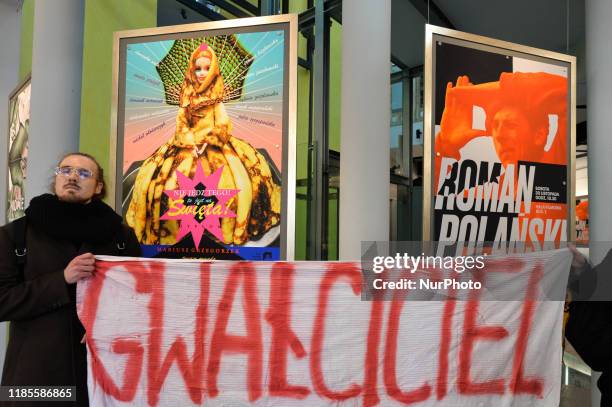 Activists hold 'Rapist' banner during a protest in 'Solidarity Against The Rape Culture In The Film Industry' at the Polish National Film School in...