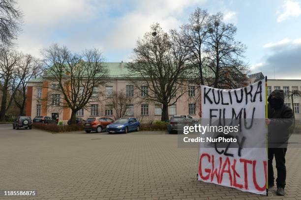 An activist holds 'Film or Rap Culture' banner during a protest in 'Solidarity Against The Rape Culture In The Film Industry' at the Polish National...