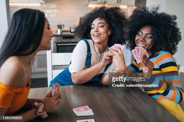 three girls at home playing cards - game night stock pictures, royalty-free photos & images