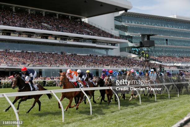 The field in race 7 the Lexus Melbourne Cup pass the post for the first time during 2019 Melbourne Cup Day at Flemington Racecourse on November 05,...