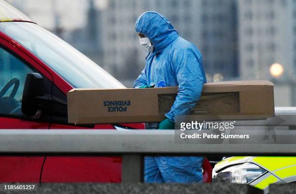 Scenes of crime officer removes a large piece of evidence from the scene of yesterday's London Bridge stabbing attack on November 30, 2019 in London,...