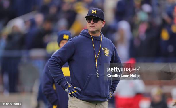 Michigan Wolverines Head Football Coach Jim Harbaugh watches the pregame warmups prior to the start of the game against the Ohio State Buckeyes at...