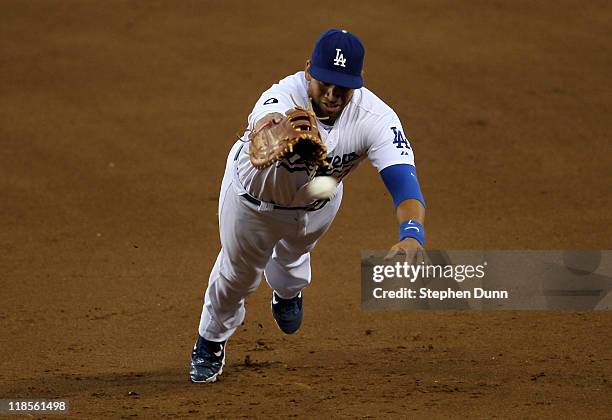 First baseman James Loney of the Los Angeles Dodgers dives unsuccessfully for a double hit by Chase Headley of the San Diego Padres in the fourth...