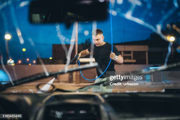 self service carwash - close up of a cleansing spray nozzle stockfoto's en -beelden