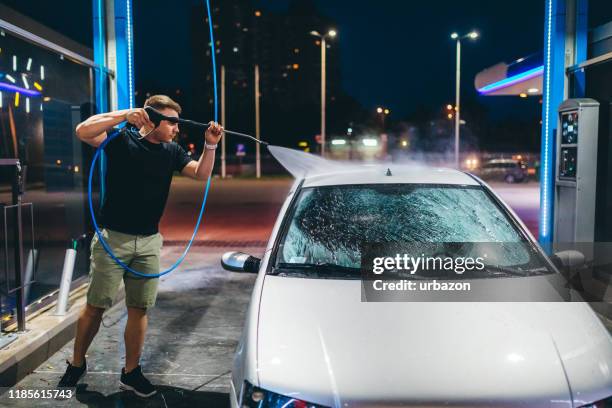 self service carwash - close up of a cleansing spray nozzle stockfoto's en -beelden