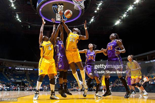 Marie Ferdinand-Harris of the Phoenix Mercury fights for a rebound with Amber Holt and Tiffany Jackson of the Tulsa Shock during the WNBA game on...