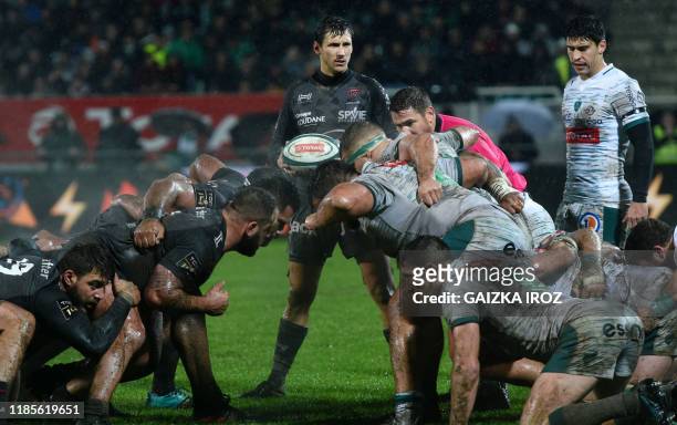 Toulon's French scrum-half Baptiste Serin looks on as players prepare to engage in a scrum during the French Top 14 rugby union match between Section...