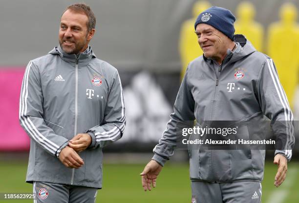 Newly appointed head coach of Bayern Muenchen Hans-Dieter Flick and his assistant coach Hermann Gerland look on during a training session at Saebener...