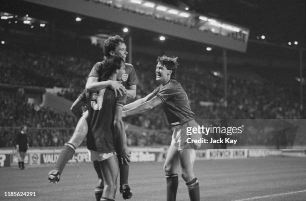 English soccer players Mark Hateley, Michael Duxbury and Steve Williams of the England national football team celebrate after scoring during a World...