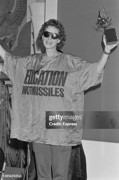 British fashion designer Katharine Hamnett wins 'Designer of the Year' at The Fashion Awards, London, UK, 15th October 1984; she is wearing a t-shirt...