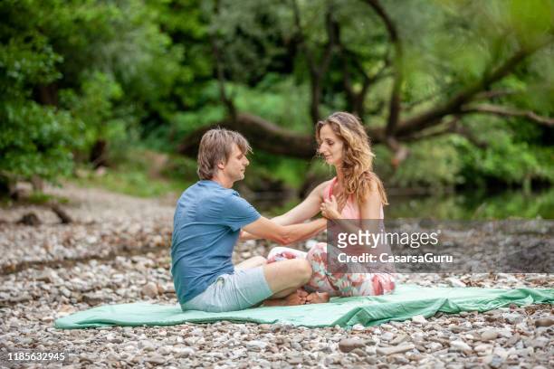 adult couple doing tantric yoga in nature and bonding - chakras stock pictures, royalty-free photos & images