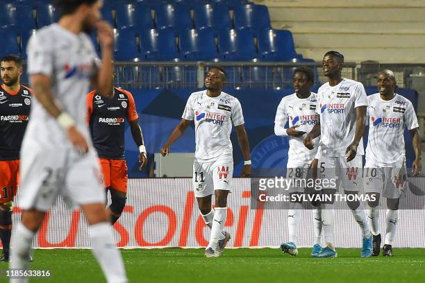 Amiens' Congolese forward Gael Kakuta is congratulated by his teammates after scoring a goal during the French L1 football match between Montpellier...