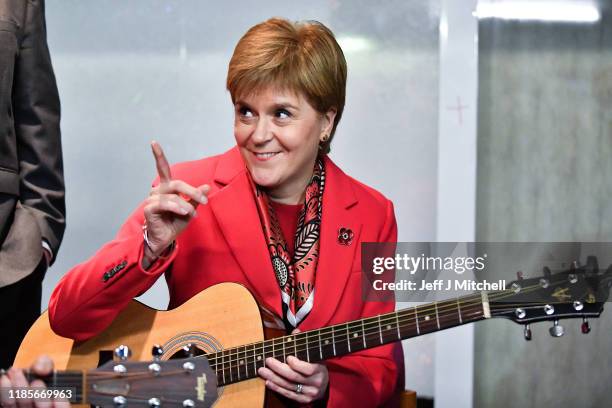 First Minister Nicola Sturgeon holds a guitar as she visits Dalkeith Community Hub with Owen Thompson, SNP election candidate for Midlothian on...