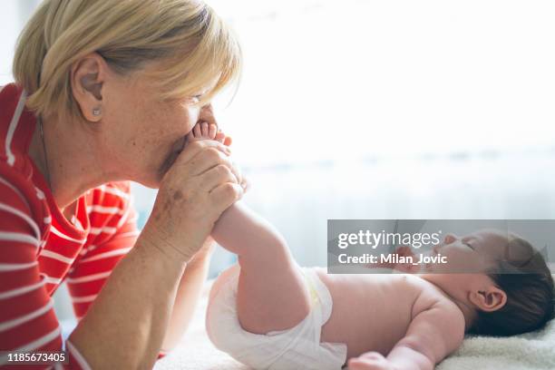 grandmothers loving touch - kissing feet stock pictures, royalty-free photos & images