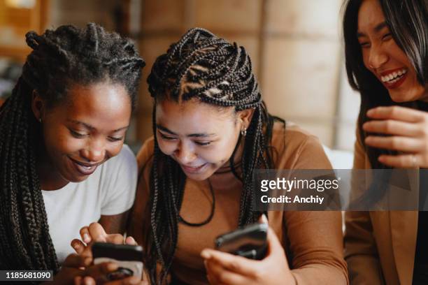 Women looking at phone using Internet dating app