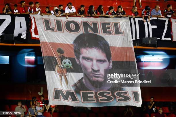 Fans of Newell's Old Boys display a banner with an image of Argentine player Lionel Messi during a match between Newell's Old Boys and River Plate as...