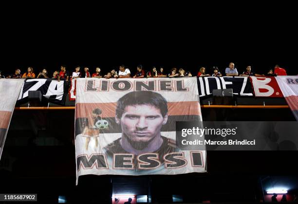 Fans of Newell's Old Boys display a banner with an image of Argentine player Lionel Messi during a match between Newell's Old Boys and River Plate as...