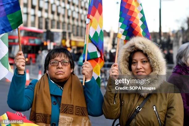 Protesters hold Wiphala flags during the rally. People gathered outside Downing Street to raise their voices against the coup in Bolivia and show...